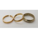 An 18ct gold wedding ring (af) and a yellow metal example with the makers mark J.Mc probably John