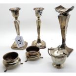 A lot comprising a silver vase (def), a pair of candlesticks (def), a mustard and two salts