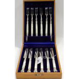 A cased twelve piece EP and mother of pearl dessert cutlery set Condition Report: Available upon