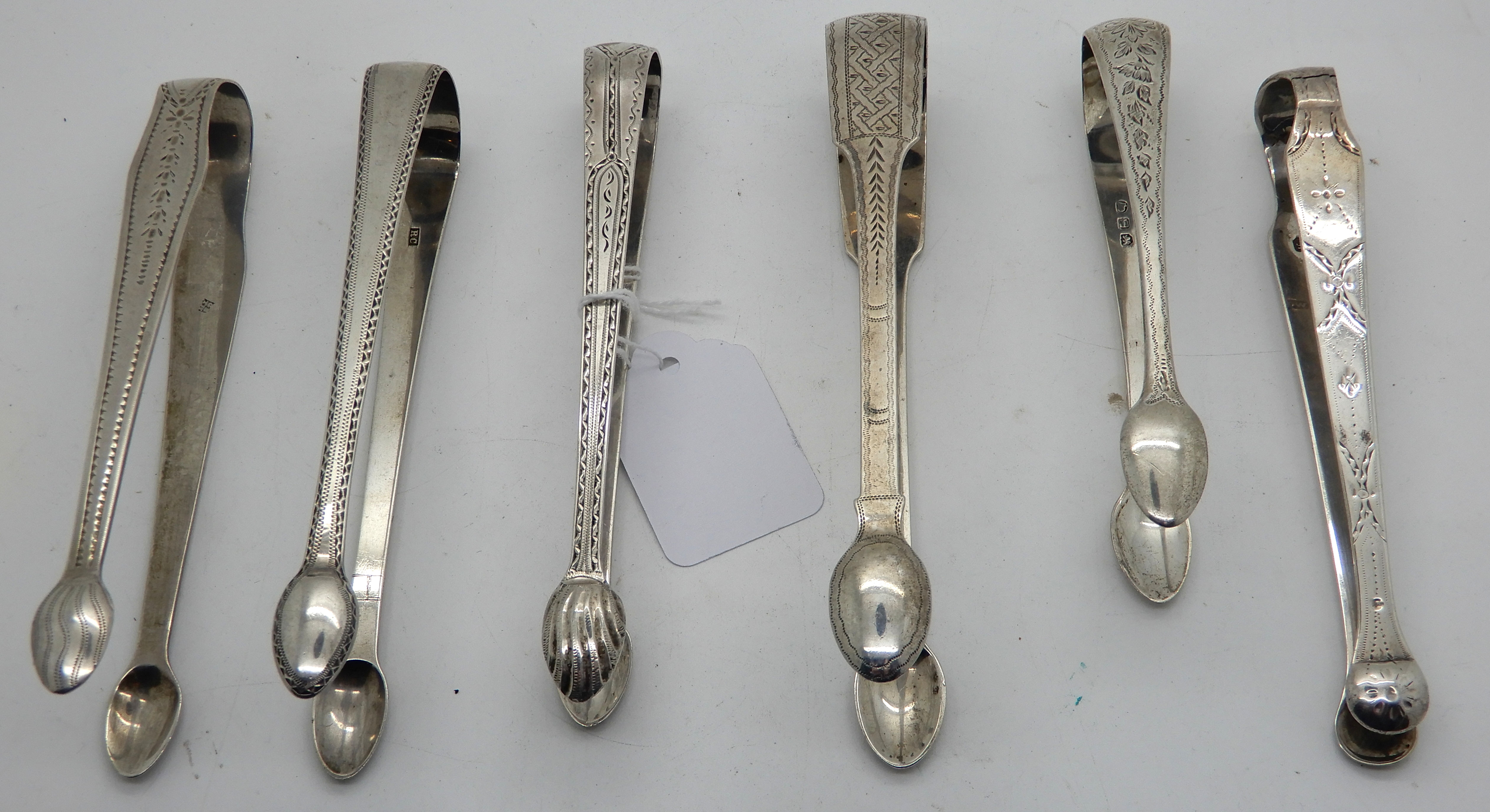 A lot comprising six pairs of assorted silver sugar tongs, 201gms Condition Report: Available upon - Image 2 of 4