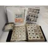 A lot comprising two albums of mainly foreign coins and banknotes Condition Report: Available upon