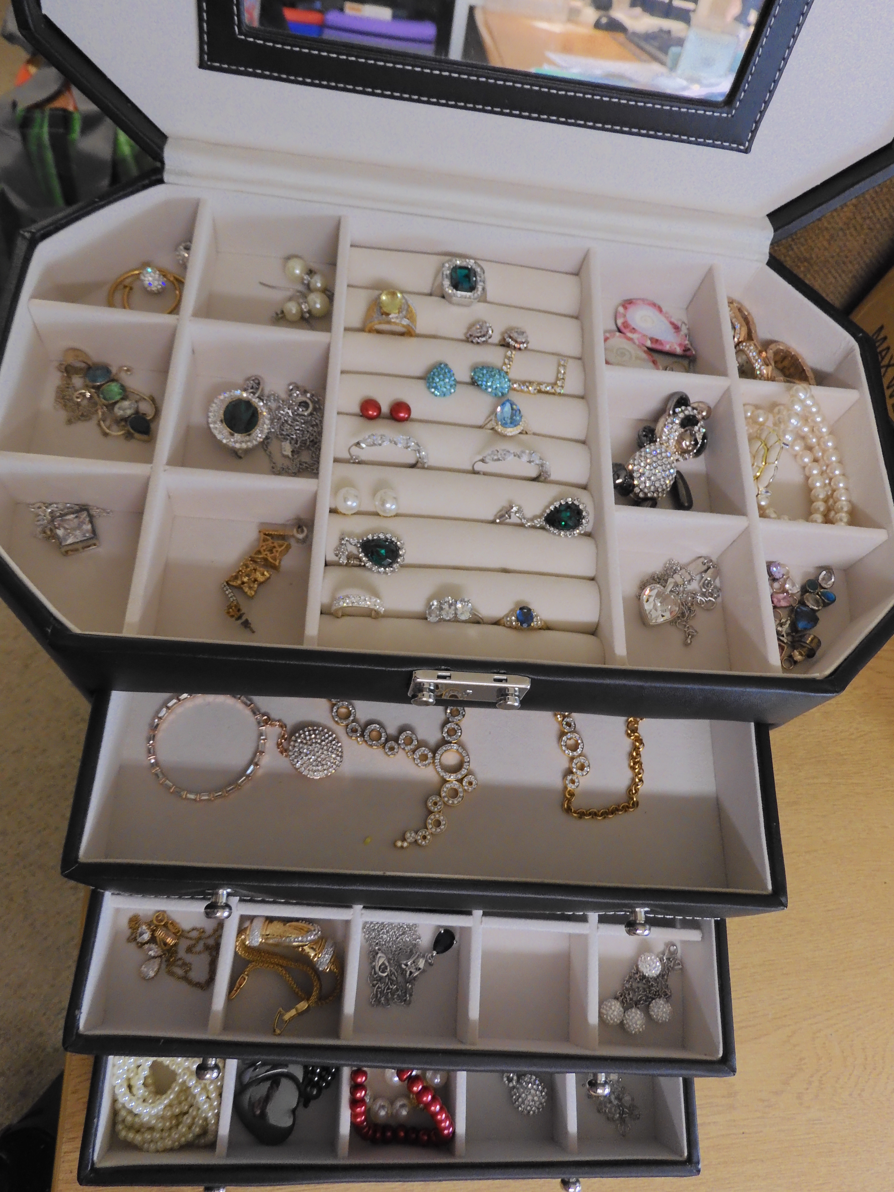 A large jewellery box full of silver and costume jewellery, to include a large gem set panda pendant