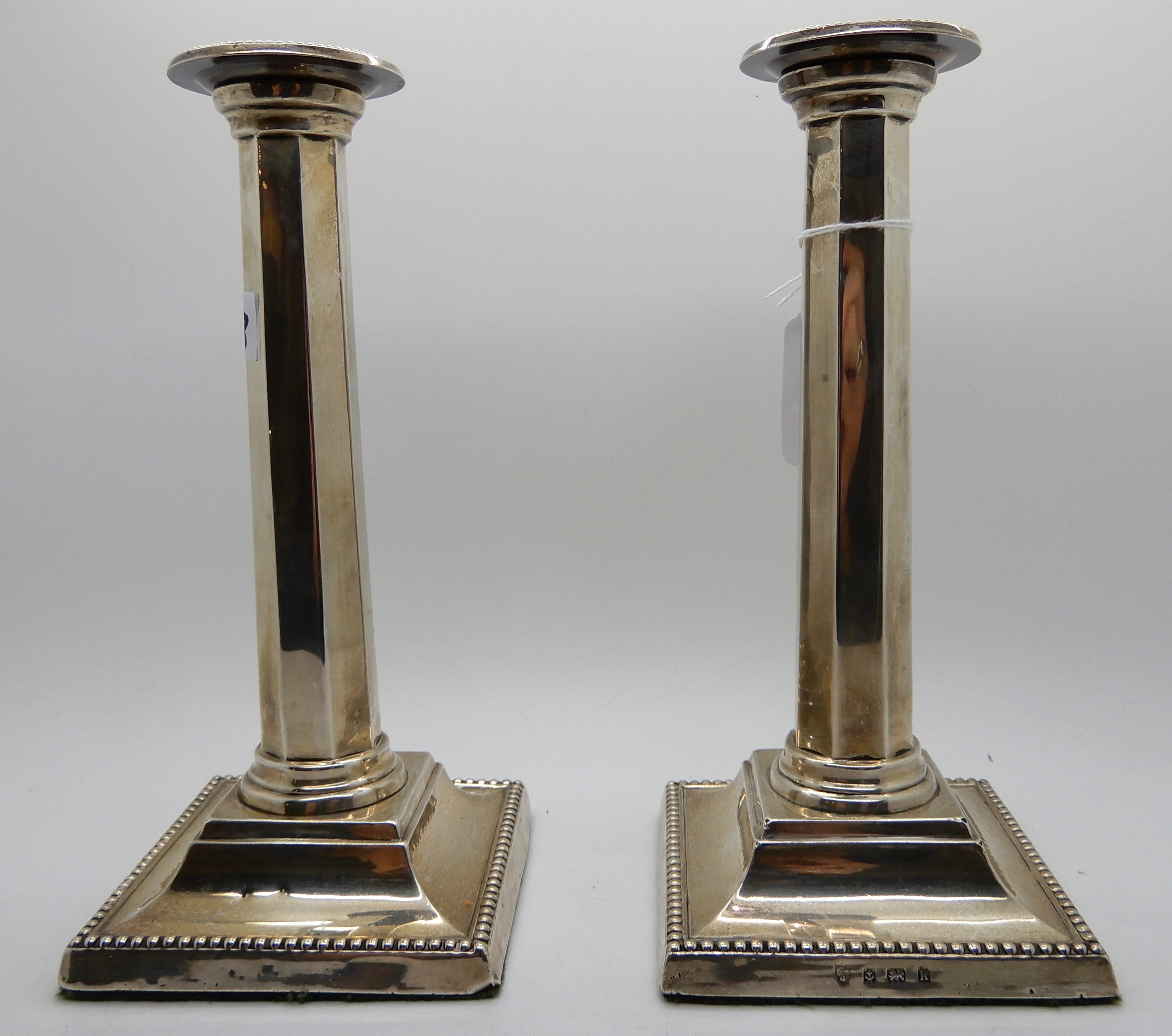 A pair of silver candlesticks, Birmingham 1909, the removable drip pans on tapering octagonal - Image 2 of 4