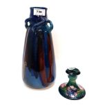 A Moorcroft Anemone candlestick and an Arts and Crafts pottery vase Condition Report: Available upon