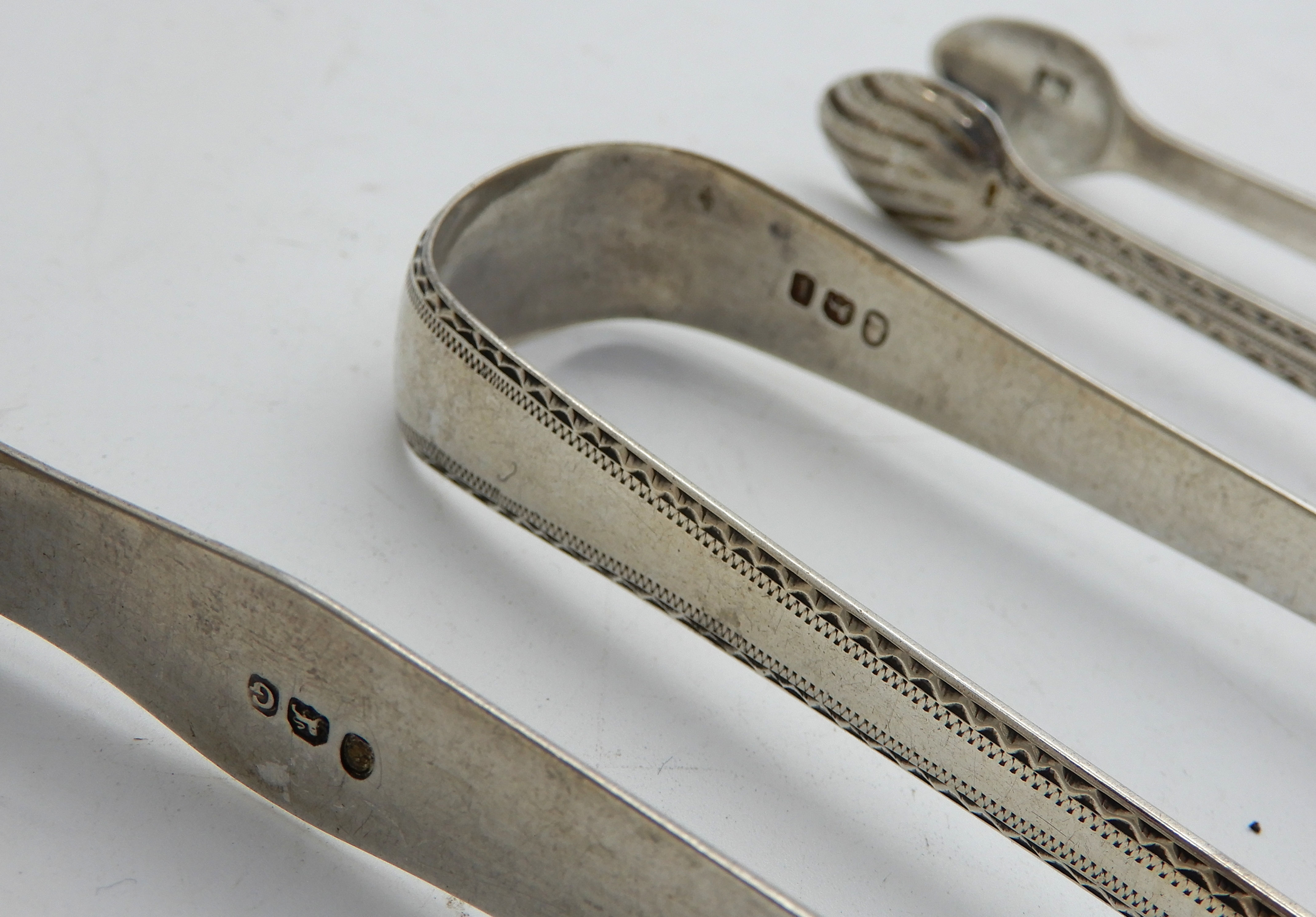 A lot comprising six pairs of assorted silver sugar tongs, 201gms Condition Report: Available upon - Image 4 of 4