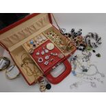 A red jewellery case full of silver and costume jewellery to include diamante pendants, a multi