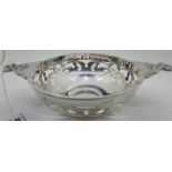 A silver quaich style bowl with pierced decoration, 26.5cm across the lugs, Sheffield 1912, 323gms