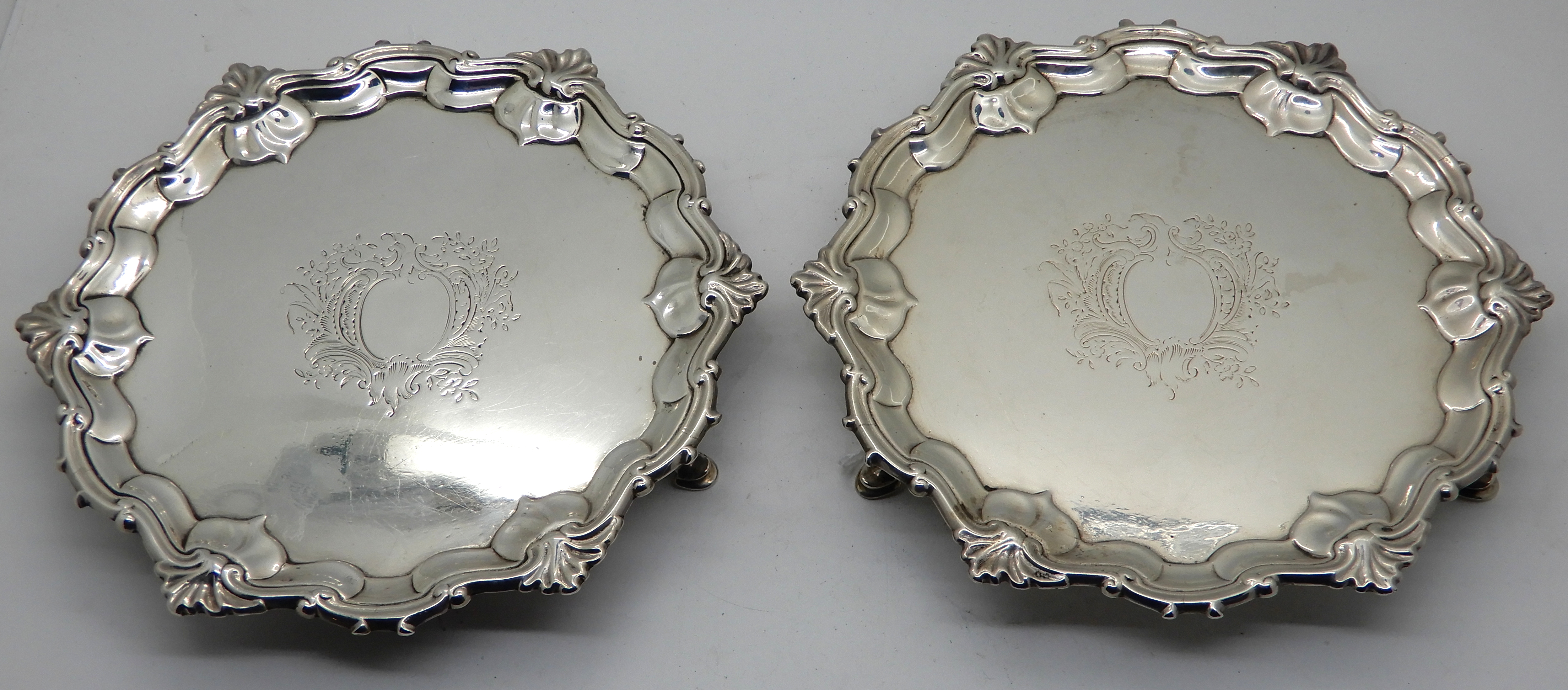 A pair of silver card trays, London 1751, of circular form with scalloped edge and shell motif on