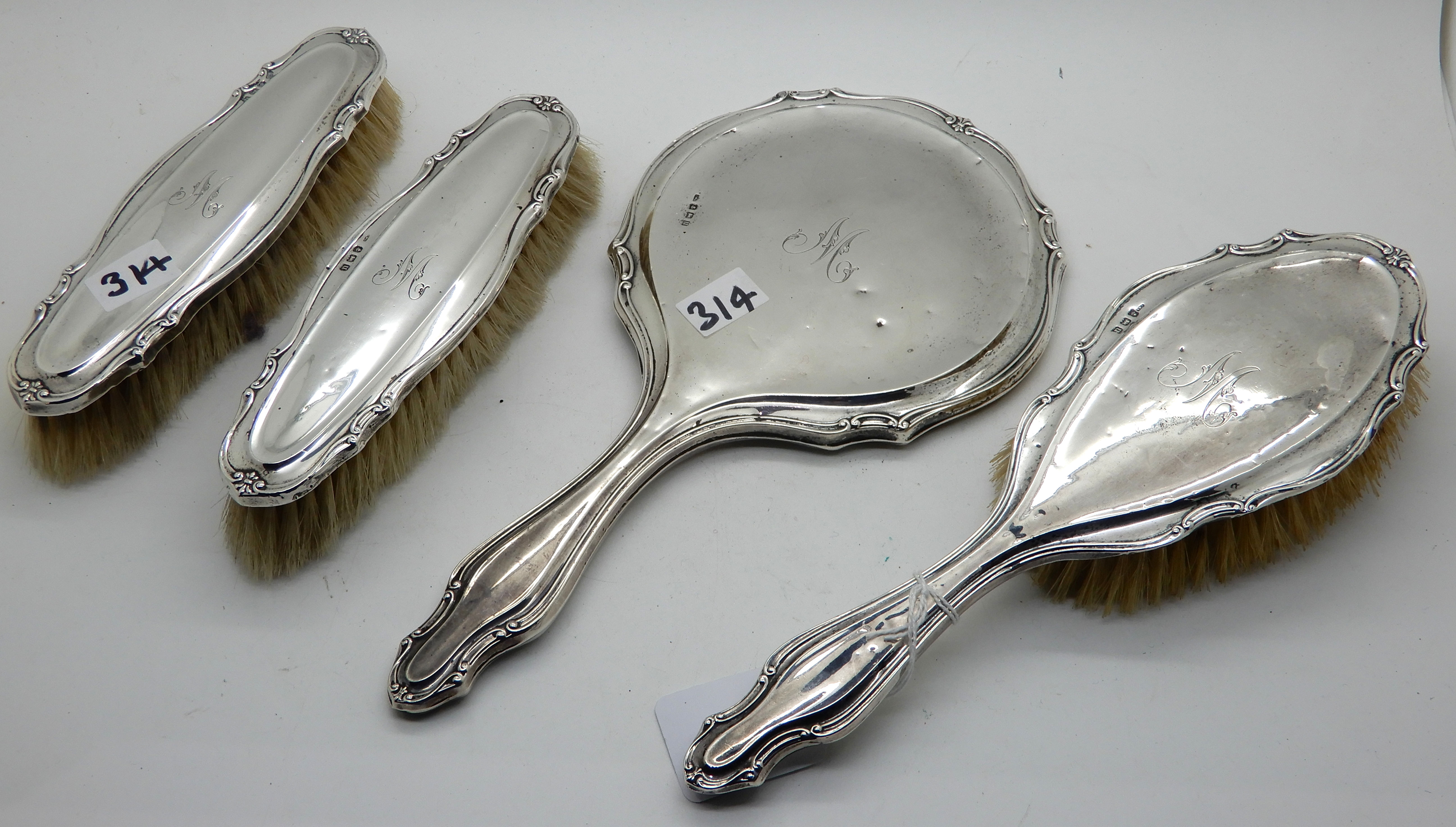 A four piece silver backed dressing table set, Birmingham 1944 Condition Report: Available upon