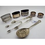 A lot comprising three silver salts, two pairs of sugar tongs (assorted marks), two EP napkin