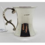 A silver tankard, Birmingham 1918, of waisted cylindrical form with scrolling handle, 8cm high,