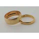 An 18ct gold wedding ring size J1/2, weight 2.9gms and a 9ct wide wedding ring size P, weight 4.5gms