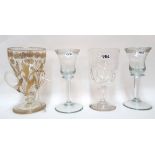 A gilt decorated glass with three handles and three other antique glasses Condition Report: