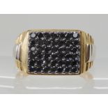 A 9ct gold gents ring set with a panel of hematite, finger size W, weight 7.1gms Condition Report: