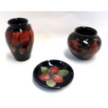 A Moorcroft miniature flambe wisteria pattern vase, 9cm high, a squat pomegranate pattern pot and
