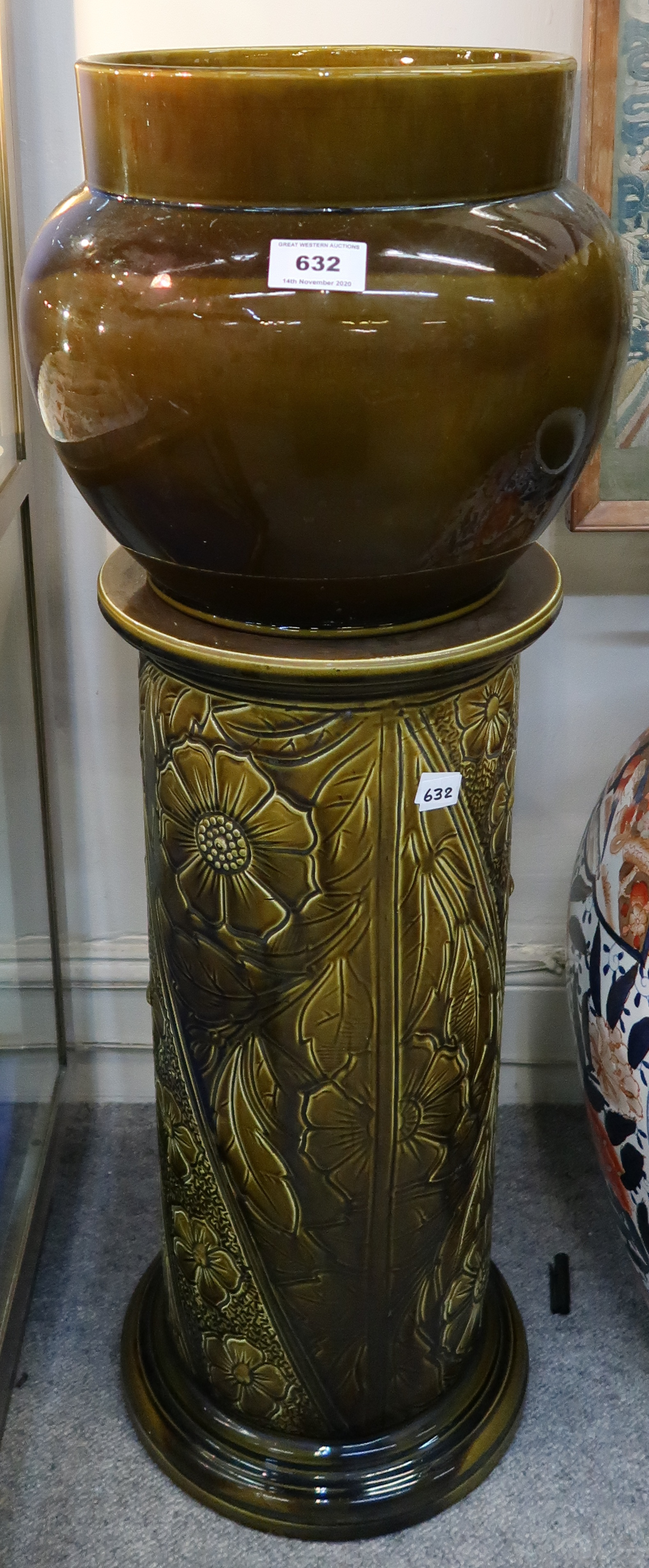 A ceramic jardiniere and stand, the base with incised decoration Condition Report: Available upon