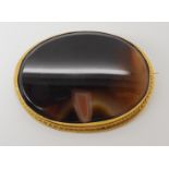A yellow metal mounted agate brooch dimensions 5.9cm x 4.4cm, weight 26.2gms Condition Report: