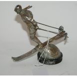 A chrome car mascot modelled as a lady skier, 14cm high Condition Report: Available upon request