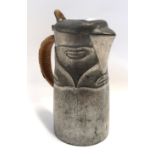 An Archibald Knox for Liberty & Co pewter hotwater jug, of tapered form and cast in low relief