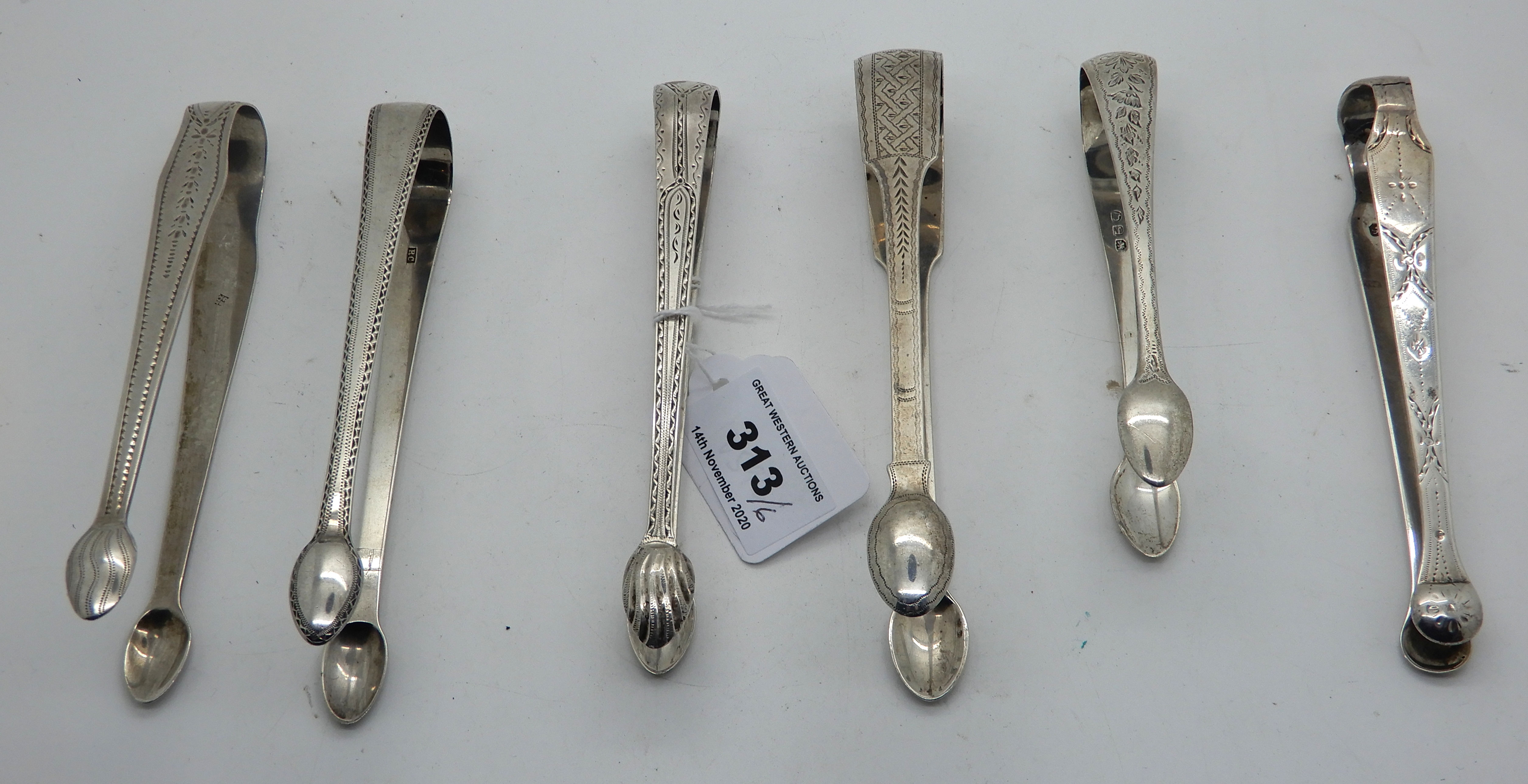 A lot comprising six pairs of assorted silver sugar tongs, 201gms Condition Report: Available upon