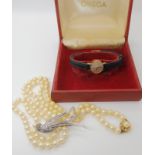 A 9ct gold cased ladies Omega watch, a string of faux pearls with a gold plated silver clasp and a