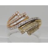 A 9ct gold diamond cluster ring set with brilliant and baguette cuts to an estimated approx