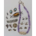 A silver and amethyst designer made necklace, a Alexander Ritchie pattern base metal brooch,