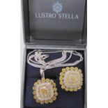 A silver mounted yellow and white diamond cluster pendant and ring from The Jewellery Channel