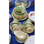 A Grosvenor China teaset, with green and gilt exterior, the inside decorated with flowers