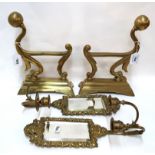 A pair of brass fire dogs and a pair of girandoles Condition Report: Available upon request