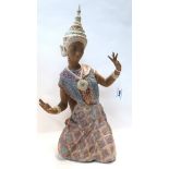 A Lladro figure of a kneeling Thai dancer Condition Report: in good condition