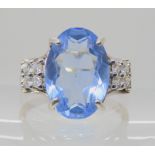 A 9ct white gold ring set with diamonds with an estimated approx total of 0.24cts and a blue paste