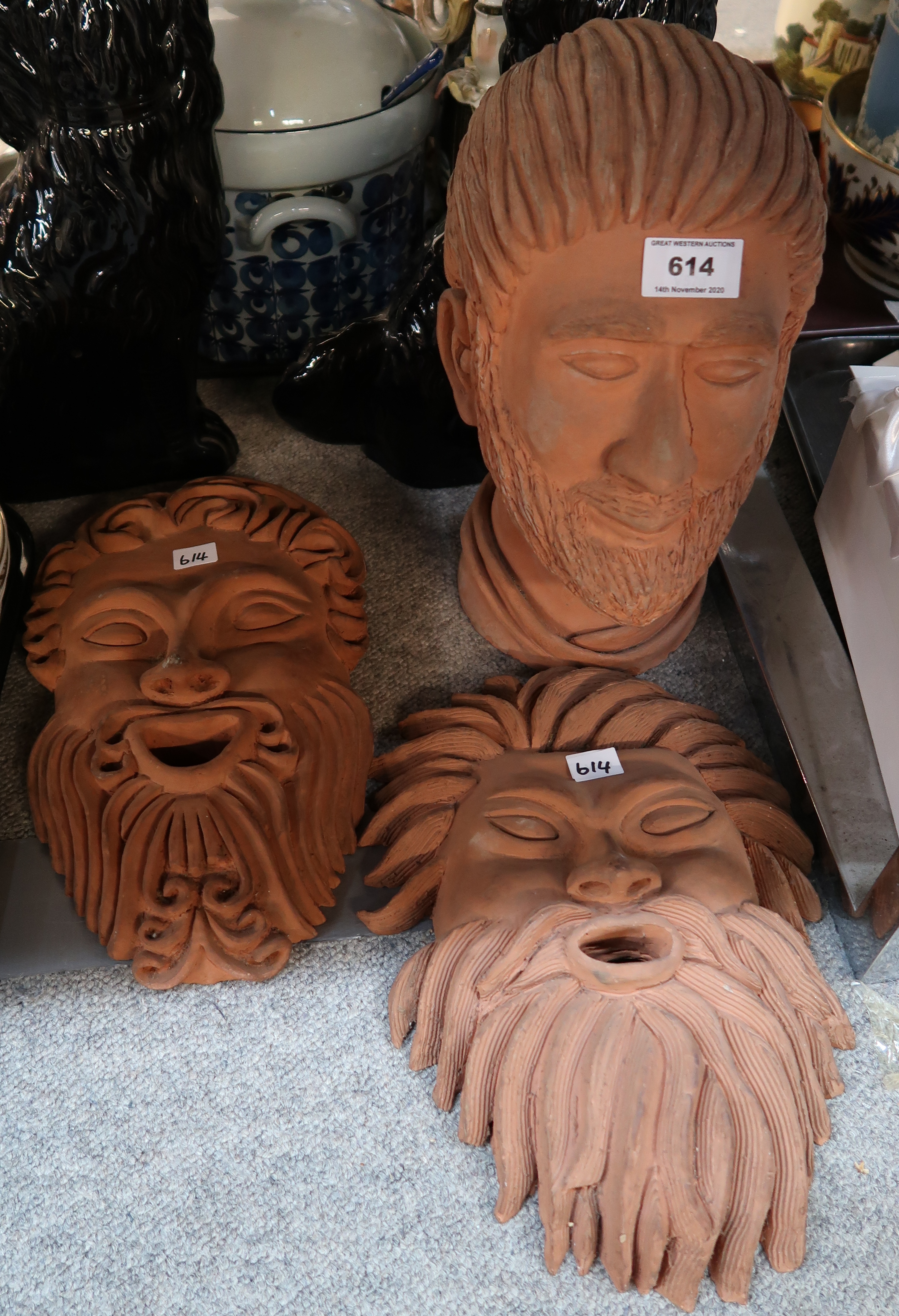 Two terracotta masks and one head Condition Report: Not available for this lot