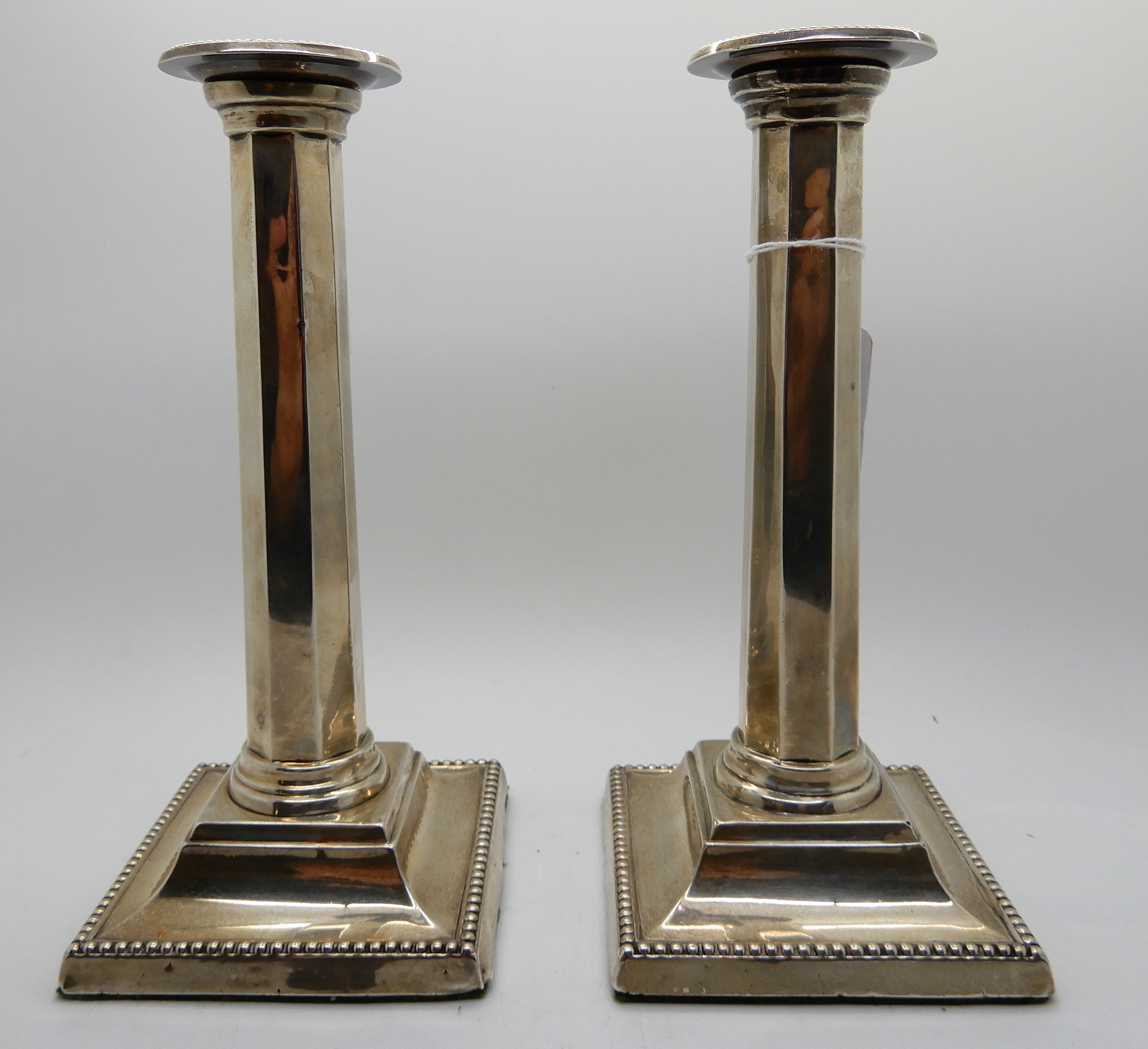 A pair of silver candlesticks, Birmingham 1909, the removable drip pans on tapering octagonal - Image 3 of 4