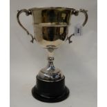 A twin handled silver plate trophy cup on socle stand "The Daily Record International Trophy",