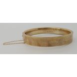 A 9ct gold bangle, inner dimensions 5.9cm x 5.1cm, weight 15.3gms Condition Report: Available upon