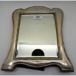 A silver mounted mirror, rubbed Birmingham marks, 30cm x 24cm, glass 20.3 cm x 15.3cm, damaged in