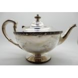 A silver teapot, Glasgow 1925, of tapering circular form with a band of Celtic decoration, bears