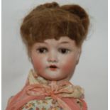 A C. M. Bergman bisque-headed doll with open and close brown eyes, painted features, 50cm long (def)