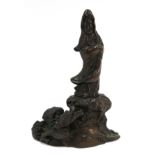 A bronzed figure of Guanyin and a dragon, 16cm high Condition Report: Available upon request