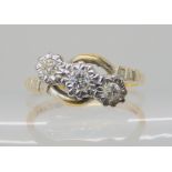 An 18ct gold and platinum three stone diamond ring, set with estimated approx 0.15cts in illusion