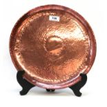 A Newlyn copper circular tray with hammered decoration Condition Report: Available upon request
