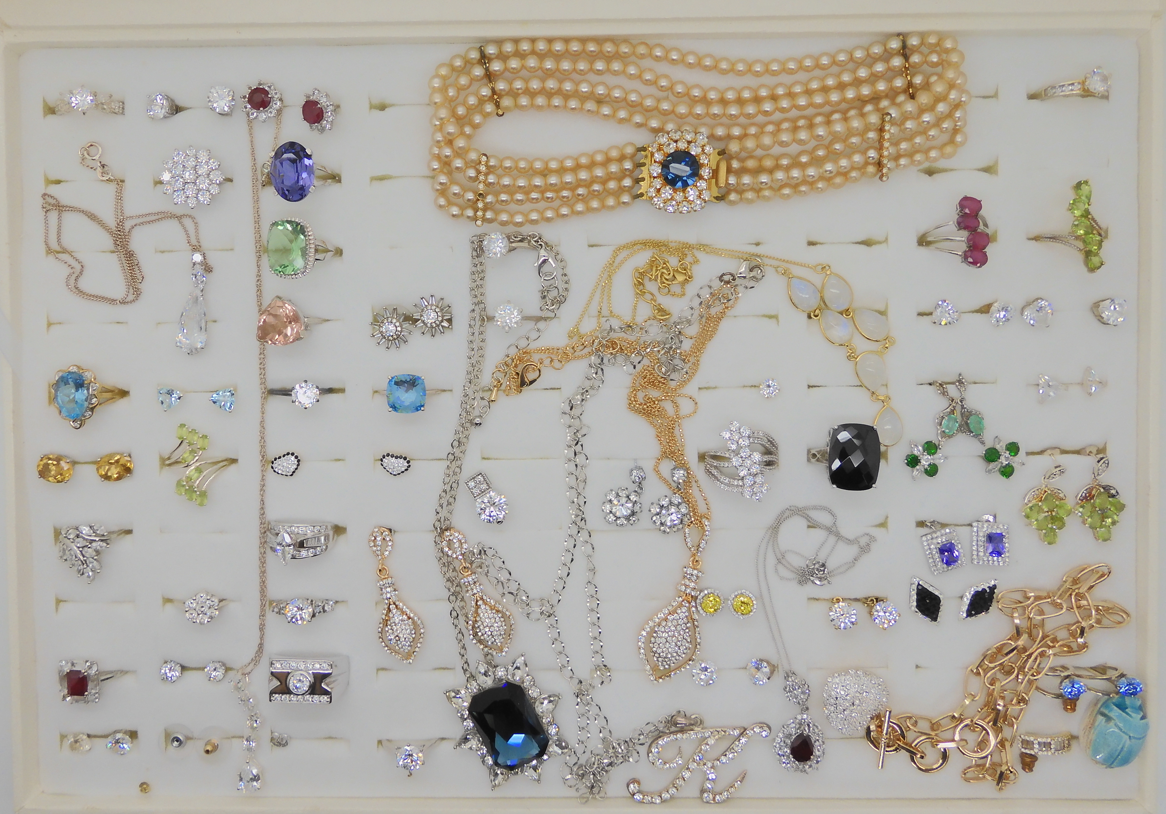 A collection of silver and costume jewellery to include a Swarovski signed zirconia ring and gem set