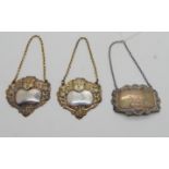 A lot comprising a pair of silver decanter labels, Port and Whisky, London 1906 and a single Port,