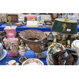 A Tole Ware style desk lamp, a wicker cornucopia centrepiece, a pink ground porcelain lamp and a