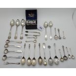 A lot comprising a cased pair of silver napkin rings with assorted silver spoons, tongs etc,