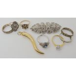 A 9ct and silver gem set eternity ring, a collection of silver and costume rings and a deco clip