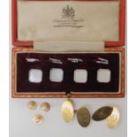 A boxed set of 9ct white gold and mother of pearl studs, a further pair of 9ct monogrammed cufflinks