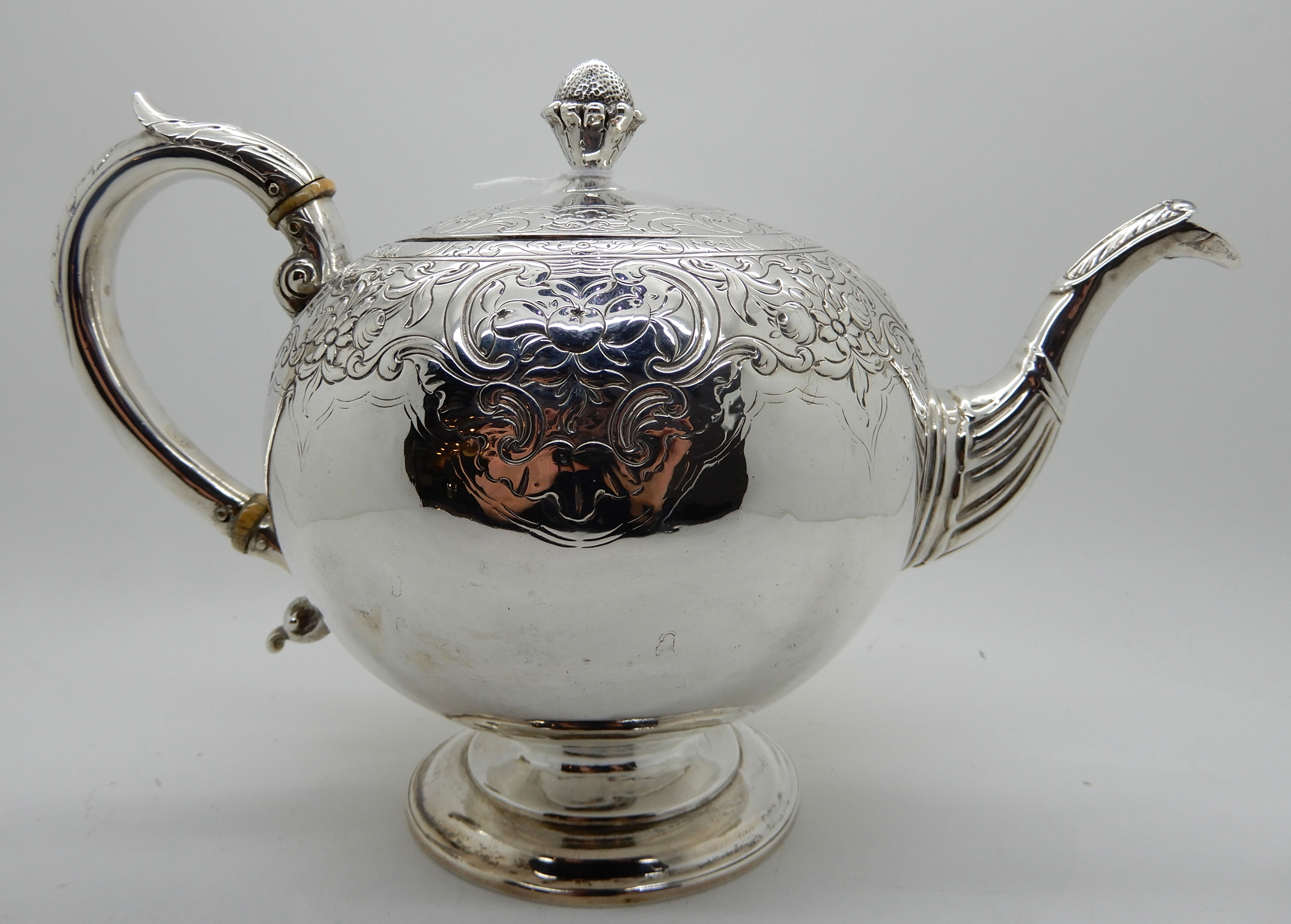 A silver teapot, Edinburgh 1804, of globular form with engraved decoration, 17cm high, 600gms