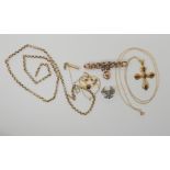 A 9ct gold garnet set cross and chain, a 9ct lovers knot brooch, a 9ct white gold eagle stud